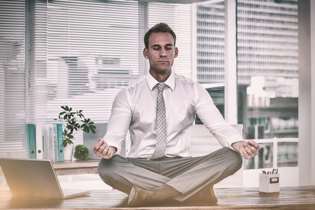 zen businessman doing yoga meditation