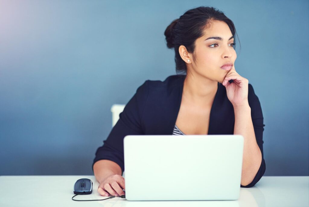 businesswoman looking distracted at her desk
